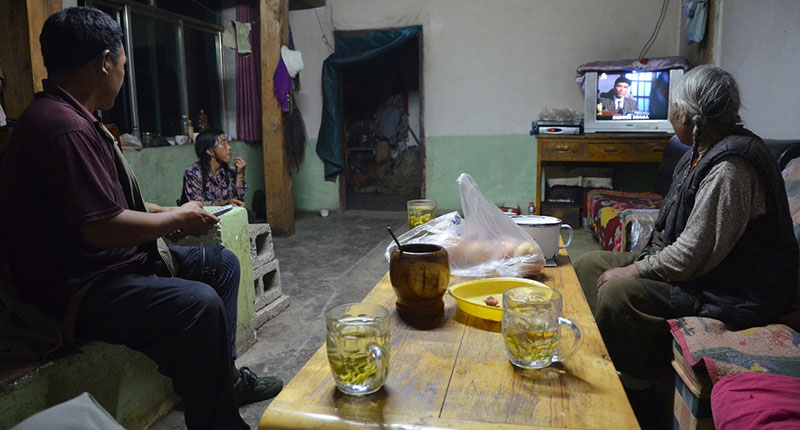 A Chinese family watching TV in their home